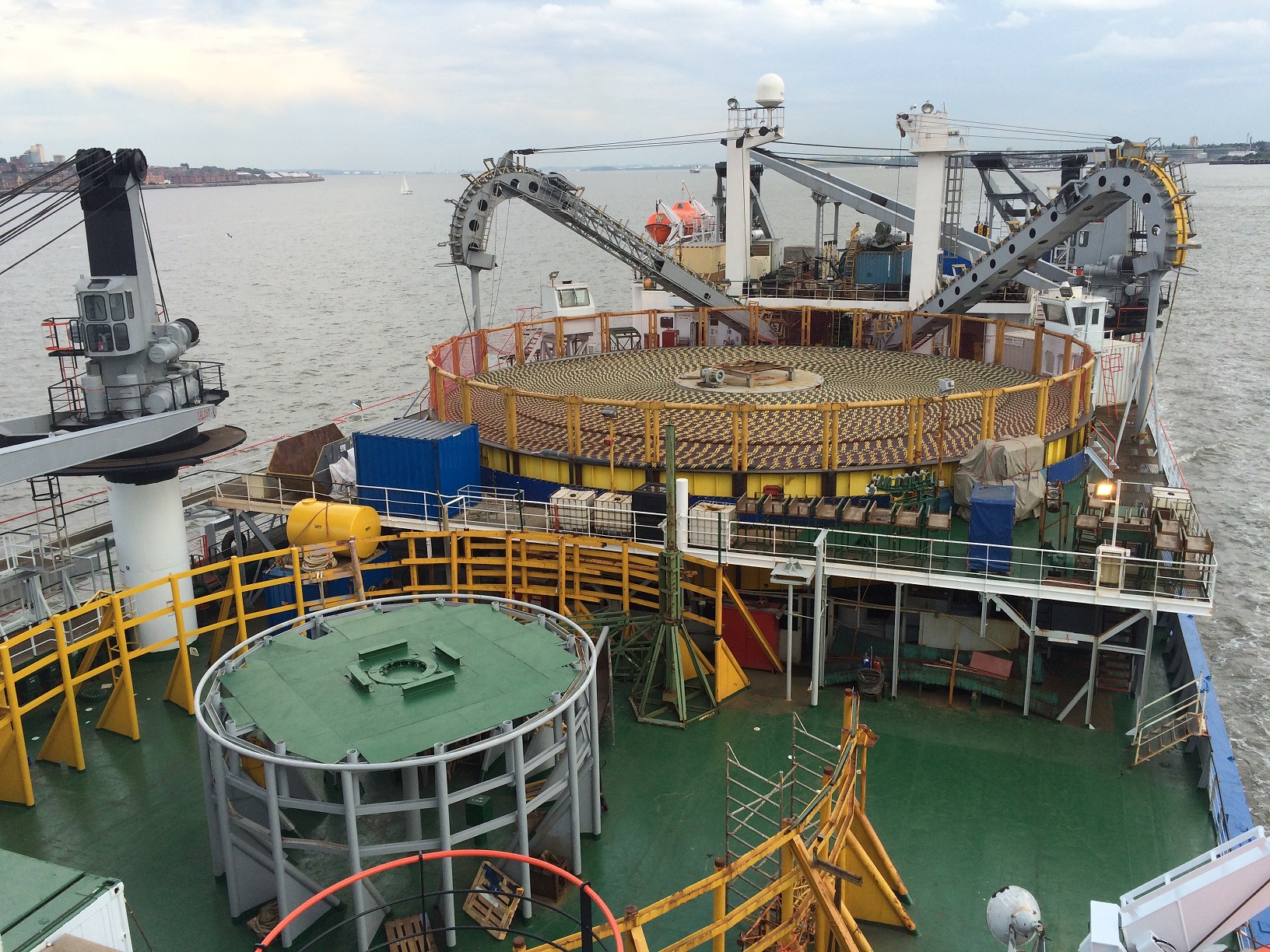 Back deck of a cable lay vessel with HVDC cable loaded in a turntable