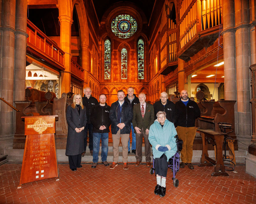 Members of Govan Heritage Trust pose for a photo inside Govan Old Church