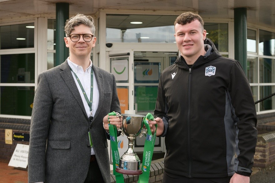 Warriors Rugby PLayer Holding Trophy